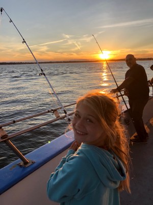 a person standing next to a body of water