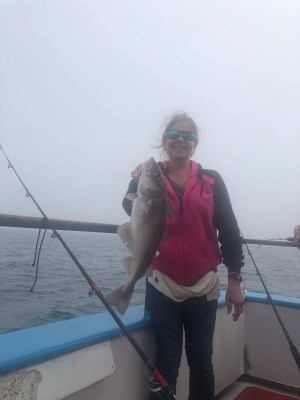 a person holding a fish in the water