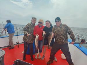 a group of people standing on a boat