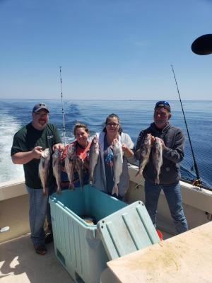 a group of people standing on a boat posing for the camera