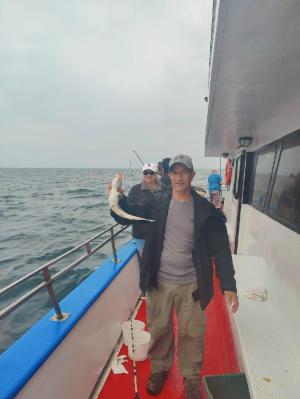 a man standing on a boat in the water