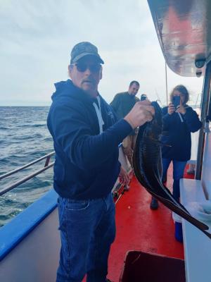 a man and a woman standing on a boat