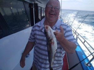 a man holding a fish