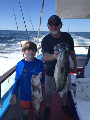a man holding a fish in the water