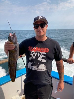 a man holding a fish in the water