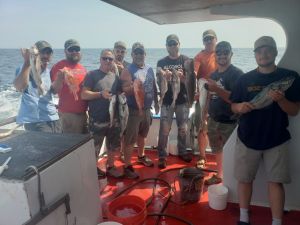 a group of people standing in front of a crowd posing for the camera