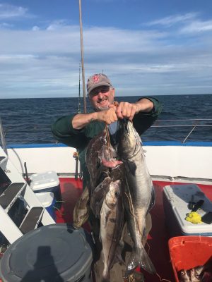 a man holding a fish in the water