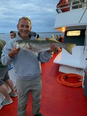 a person holding a fish