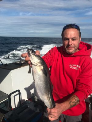 a man holding a fish in the water