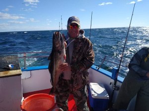 a person holding a fish in the water