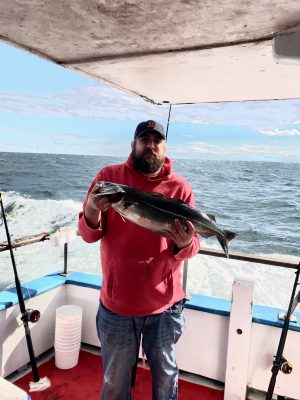 a man holding a fish in the water