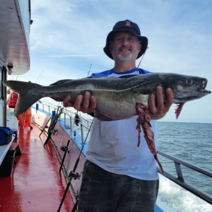 a man holding a fish in the water