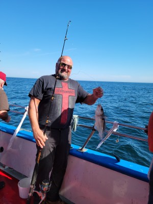 a group of people standing next to a body of water