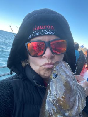 a close up of a person holding a fish