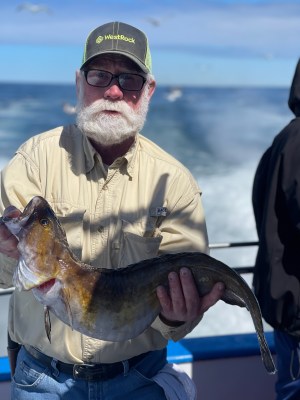 a man holding a fish in the water