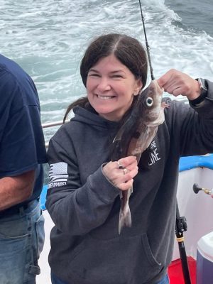 a person holding a fish in the water