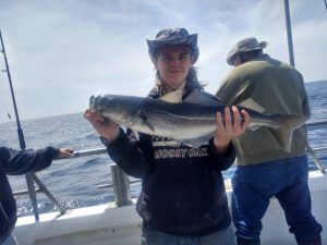 a person holding a fish in the water
