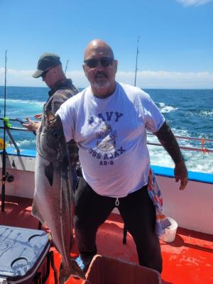 a man holding a fish in the water