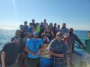 a group of people standing in front of a crowd posing for the camera