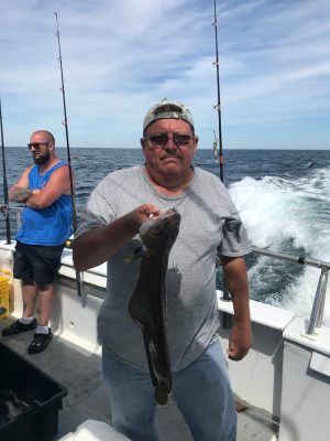 a man holding a fish in the water