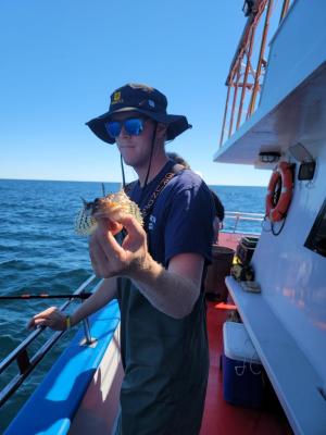 a man standing on a boat in the water