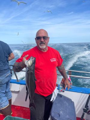 a man holding a fish in the water