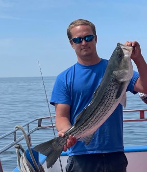 a man holding a fish in the water