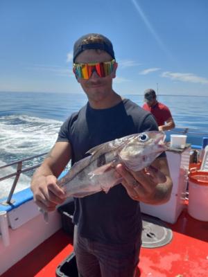 a person holding a fish in the water