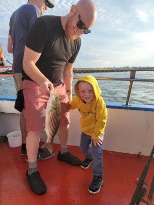 a man holding a fish in the water