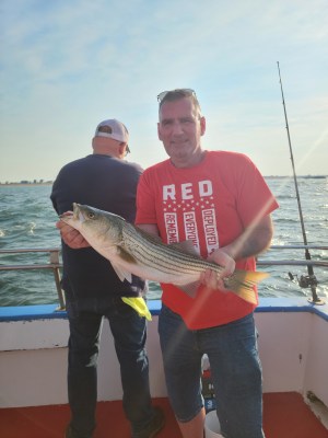 a man holding a fish in the water