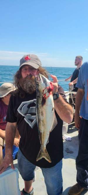 a person holding a fish in the water