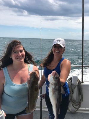 a woman holding a fish in the water