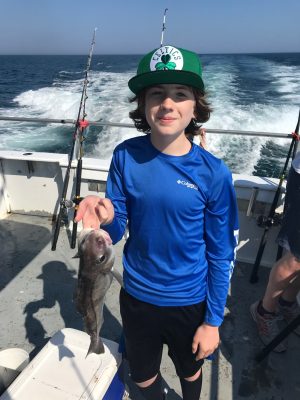 a person holding a fish in the water