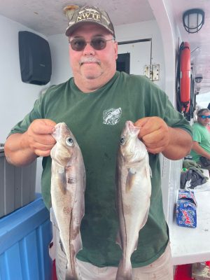 a man holding a fish