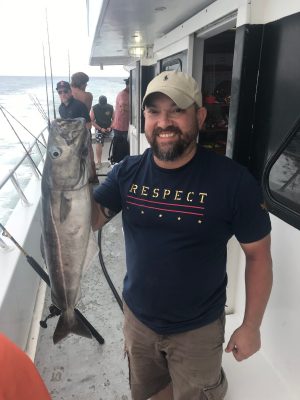 a man holding a fish
