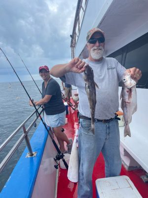 a person holding a fish on a boat