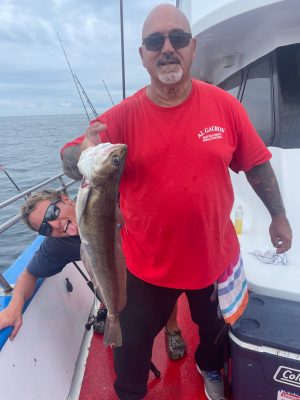 a man holding a fish in the water