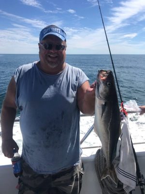 a man holding a fish in the water