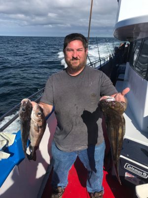 a man holding a fish in the water