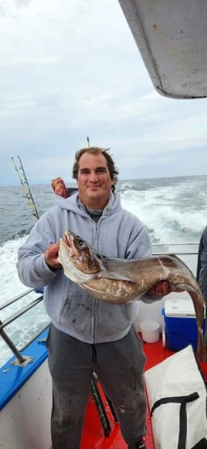 a person holding a fish in the water