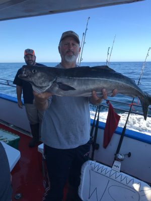 a person holding a fish in the water