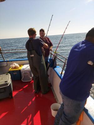 a couple of people standing next to a body of water
