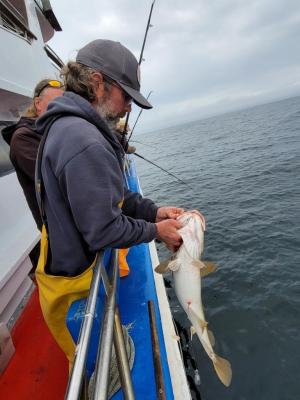 a man holding a fish in the water