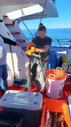 a person standing next to a boat