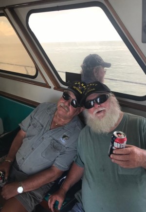 a man standing next to a window